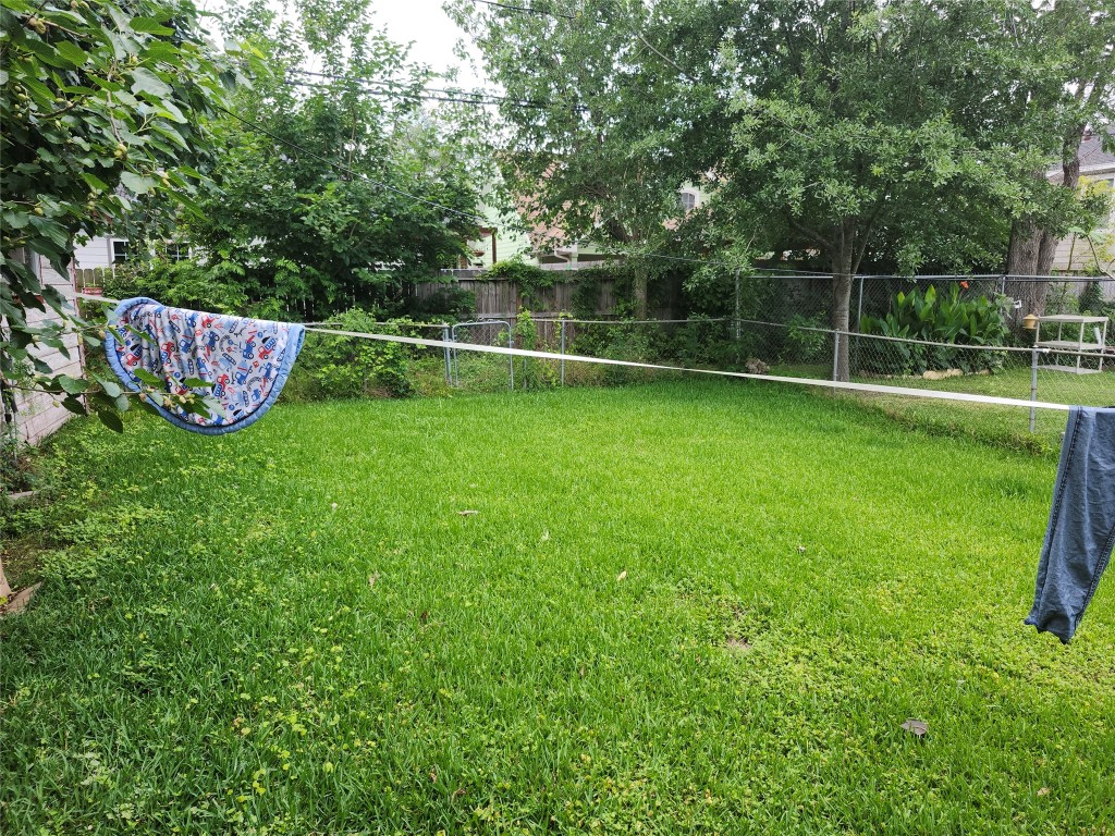 4215 Edison Street Houston, TX 77009 - Photo 6 of 13 a view of a backyard with a wooden fence