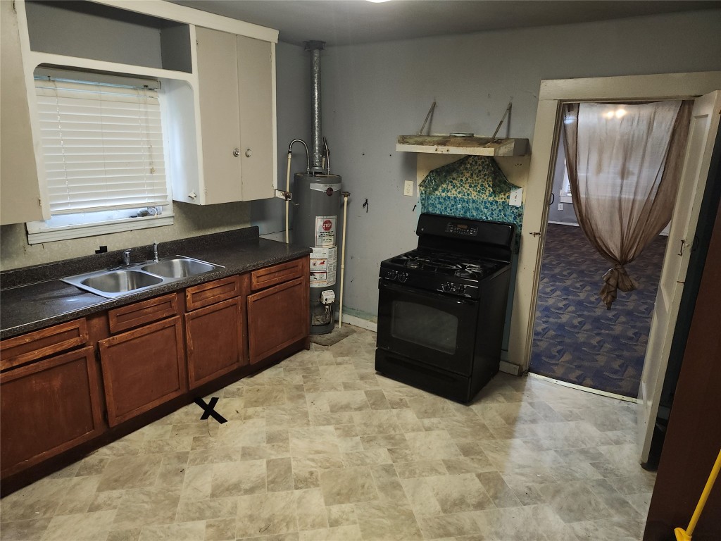 4215 Edison Street Houston, TX 77009 - Photo 8 of 13 a kitchen with granite countertop a refrigerator and a stove top oven