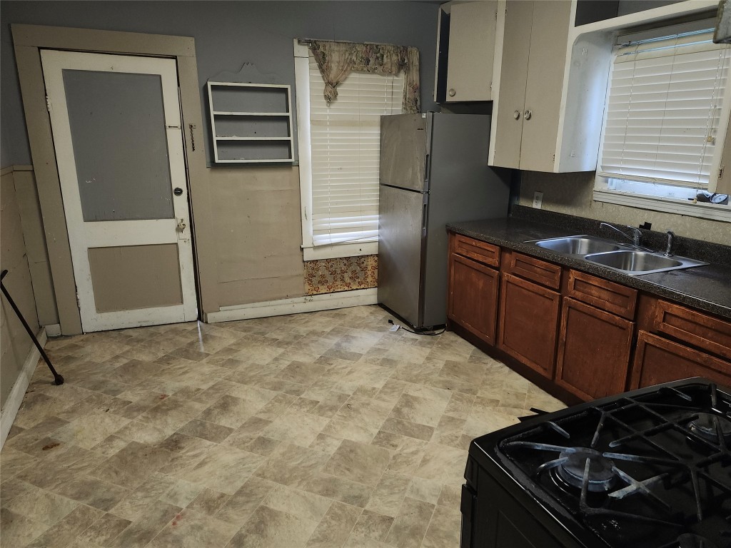 4215 Edison Street Houston, TX 77009 - Photo 9 of 13 a kitchen with a refrigerator and a stove