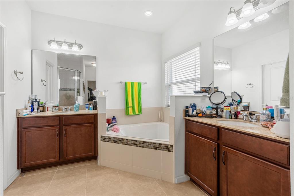 2085 Lula Road Minneola, FL 34715 - Photo 30 of 39 a bathroom with a sink vanity tub and shower