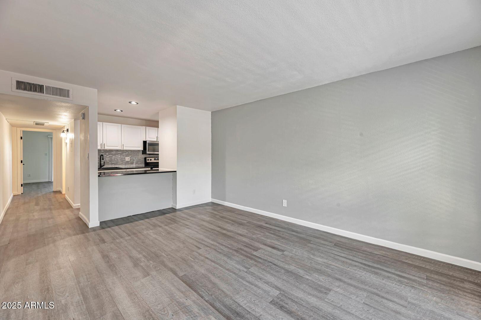 4231 North 13th Place, Unit 110 Phoenix, AZ 85014 - Photo 3 of 9 a view of kitchen with wooden floor