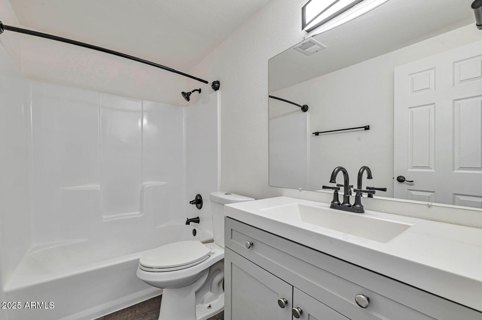 4231 North 13th Place, Unit 110 Phoenix, AZ 85014 - Photo 5 of 9 a bathroom with a sink a toilet and shower