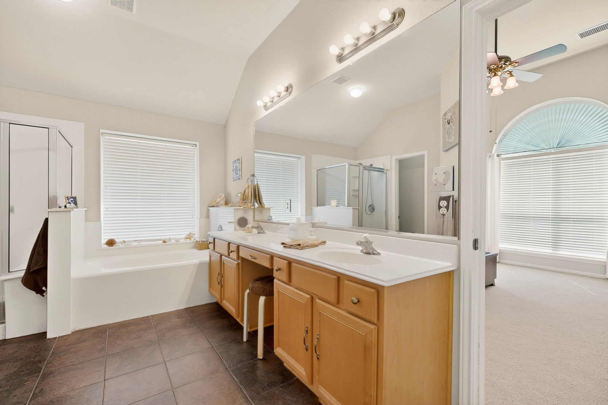 905 Victoria Ridge Drive Pflugerville, TX 78660 - Photo 18 of 32 Indulge in a tranquil primary bath featuring a spacious vanity, tiled flooring, and an inviting soaking tub.