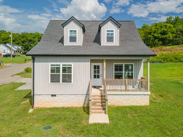 a front view of a house with a yard