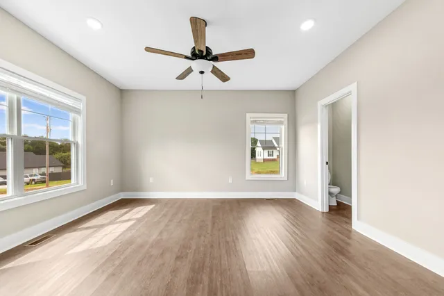 a kitchen with wooden floors appliances and cabinets