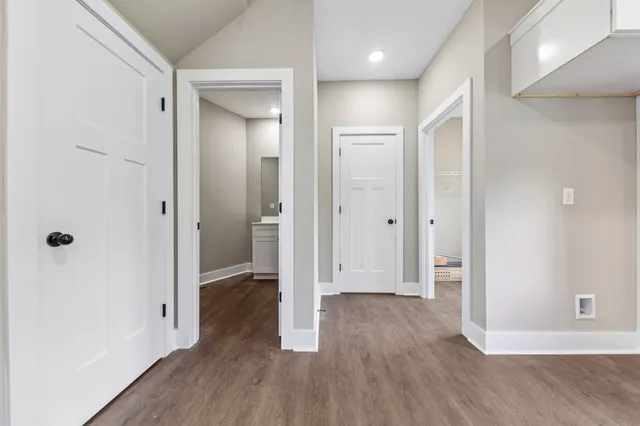 a kitchen with granite countertop white cabinets and stainless steel appliances