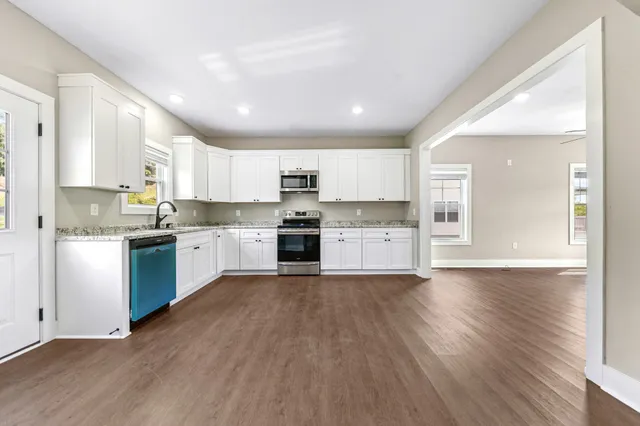 a view of a kitchen with a sink and a stove top oven