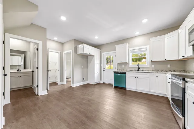 an empty room with fan and windows