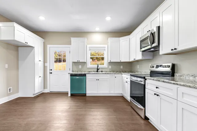 an empty room with a window and a ceiling fan