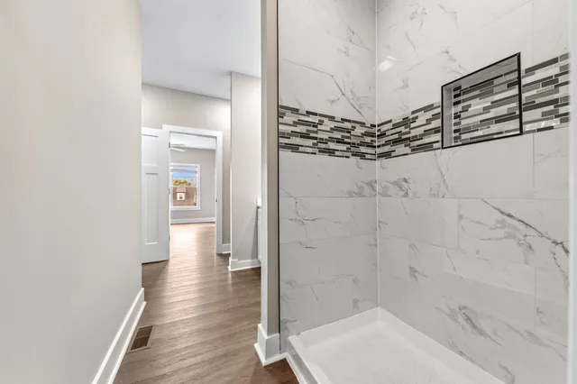 a spacious bathroom with a toilet sink and a mirror
