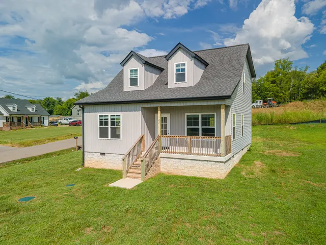 a front view of a house with a yard table and chairs