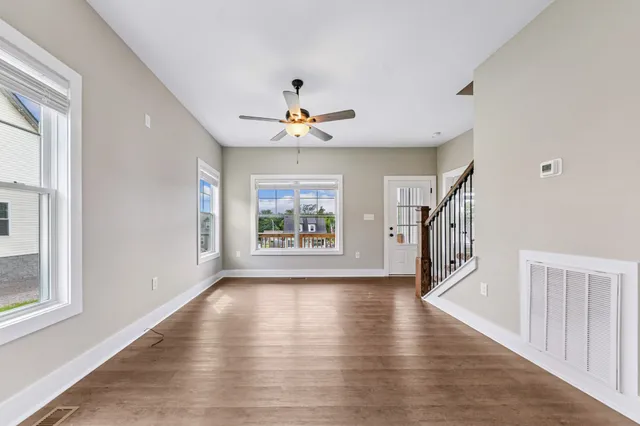 a view of an entryway with wooden floor and stairs