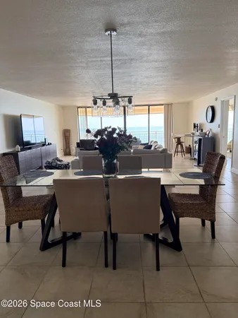 a room with table chairs and window