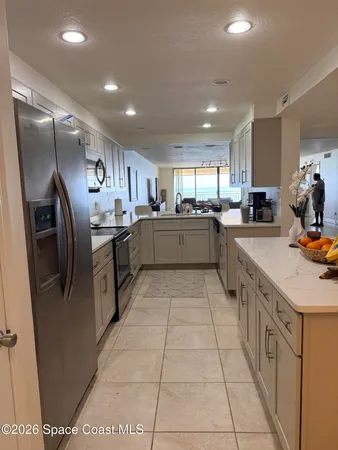 a kitchen with stainless steel appliances granite countertop a sink counter space cabinets and a large window