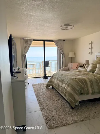 a bedroom with a large bed and a large window