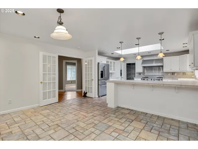 a view of a kitchen with kitchen sink and refrigerator