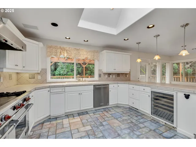 a kitchen with a sink window and cabinets
