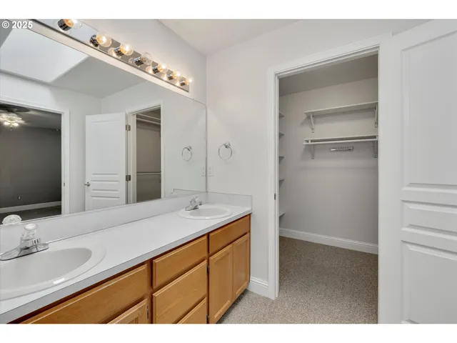 a bathroom with a sink double vanity and a mirror