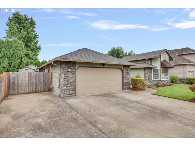 a view of a house with a yard and garage