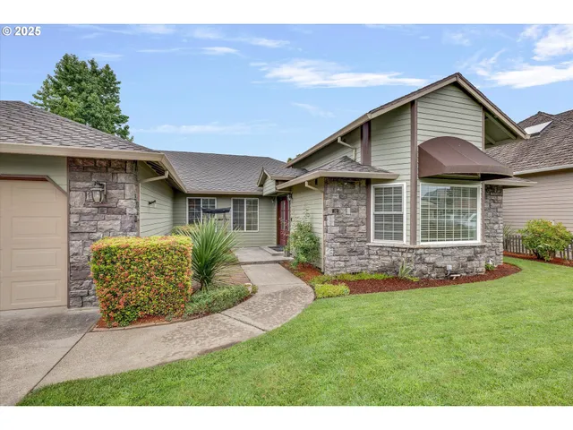 a front view of a house with a garden