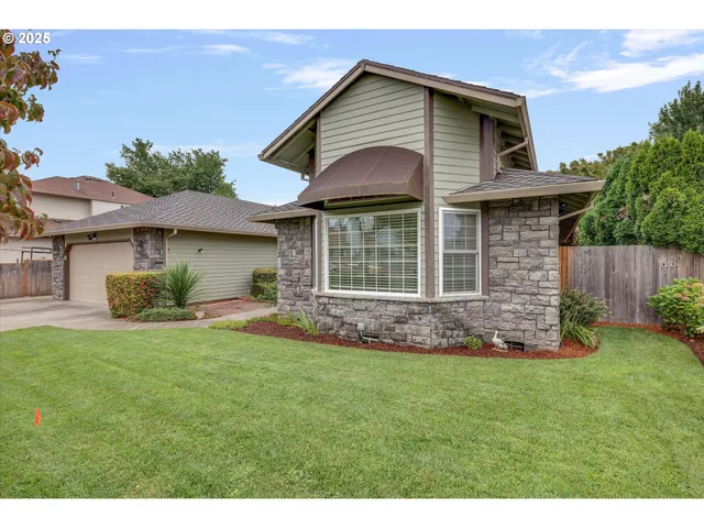 a front view of a house with a garden
