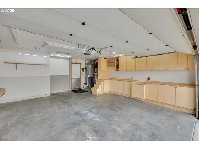 a view of a kitchen with cabinet and a view of living room