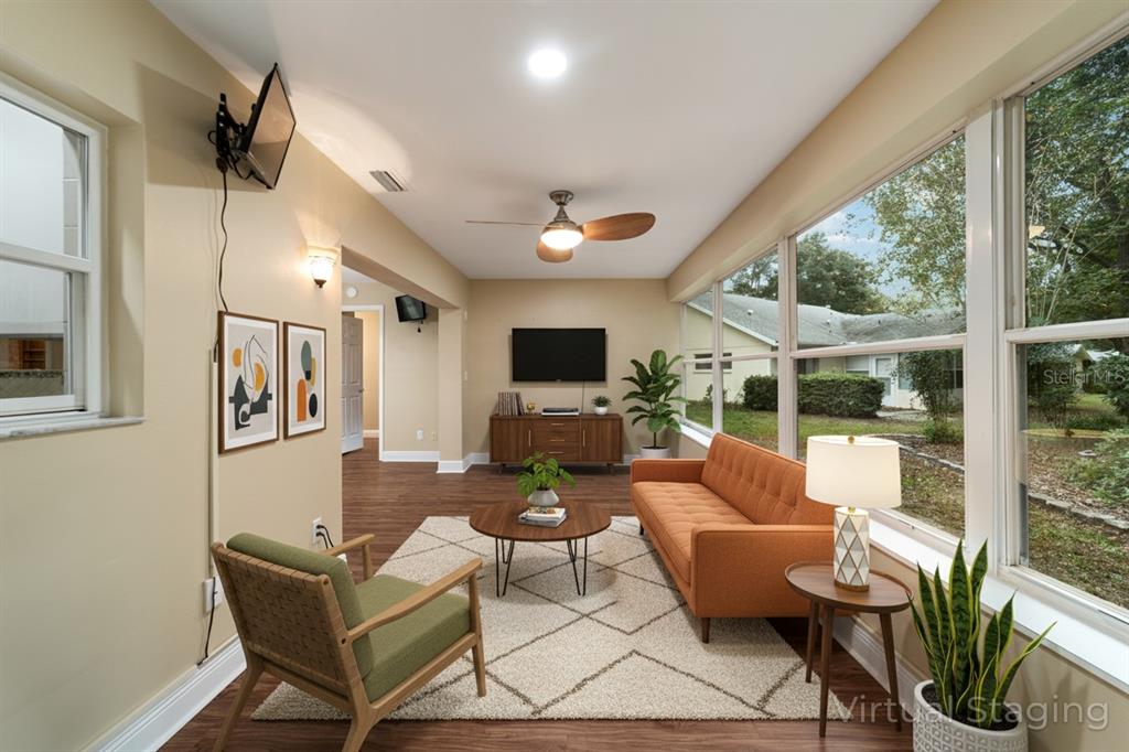 9068 Southwest 82nd Terrace, Unit A Ocala, FL 34481 - Photo 10 of 30 a living room with patio furniture and a flat screen tv