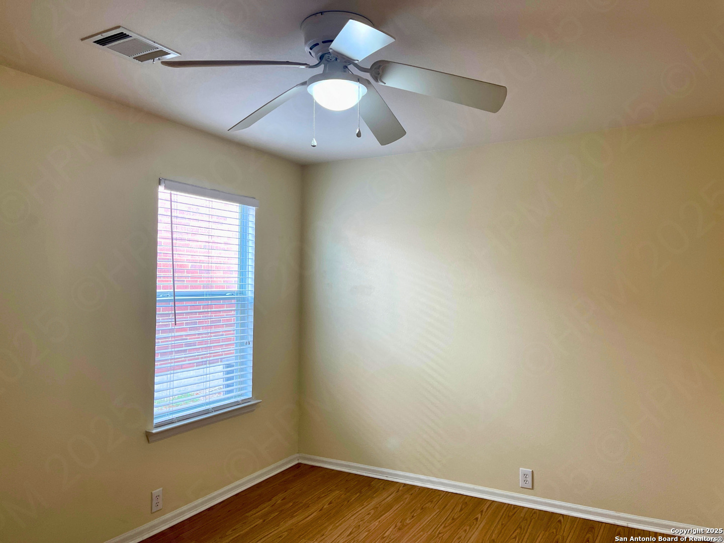 9523 Ascending Port Converse, TX 78109 - Photo 12 of 18 an empty room with a window and a fan