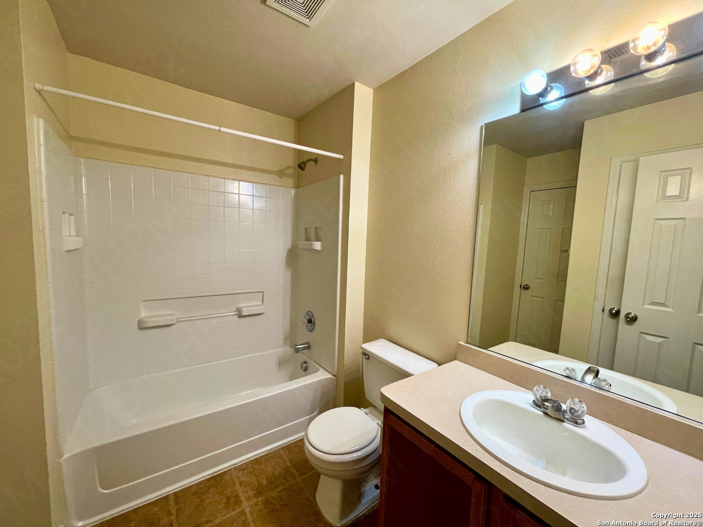9523 Ascending Port Converse, TX 78109 - Photo 14 of 18 a bathroom with a sink toilet mirror and shower