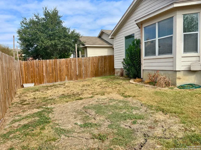 a view of a backyard of the house