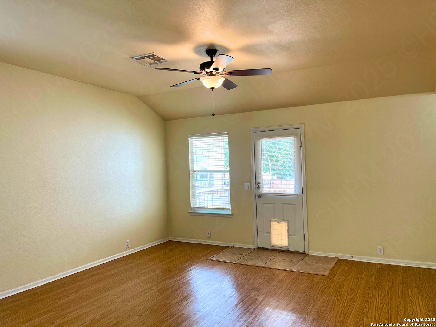 9523 Ascending Port Converse, TX 78109 - Photo 5 of 18 a view of an empty room with wooden floor and a window