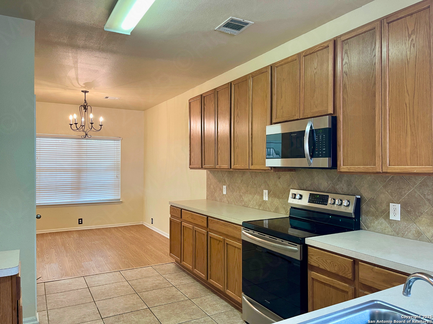 9523 Ascending Port Converse, TX 78109 - Photo 7 of 18 a kitchen with stainless steel appliances granite countertop a stove a sink and a microwave
