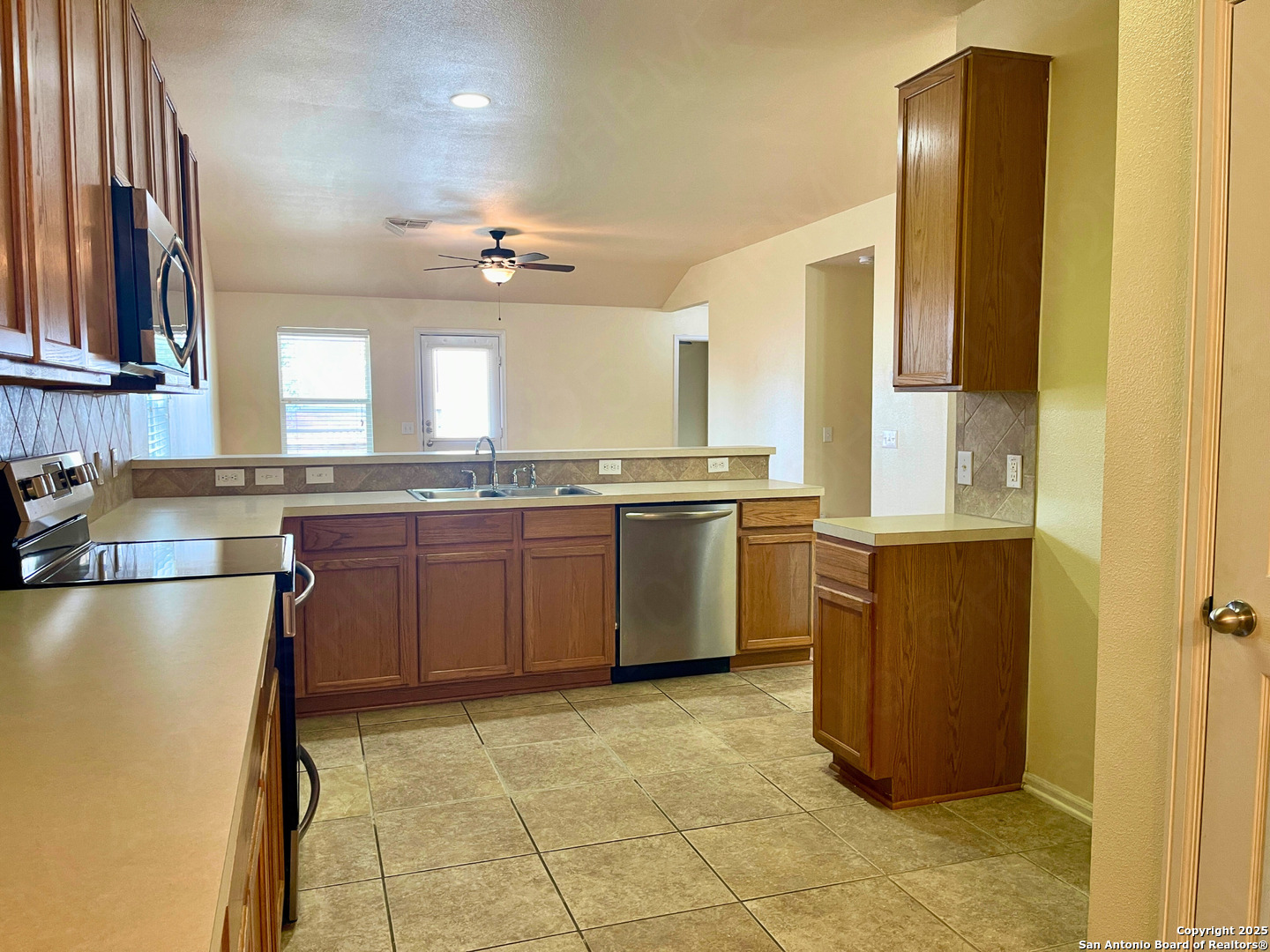 9523 Ascending Port Converse, TX 78109 - Photo 9 of 18 a kitchen with stainless steel appliances granite countertop a sink stove and refrigerator