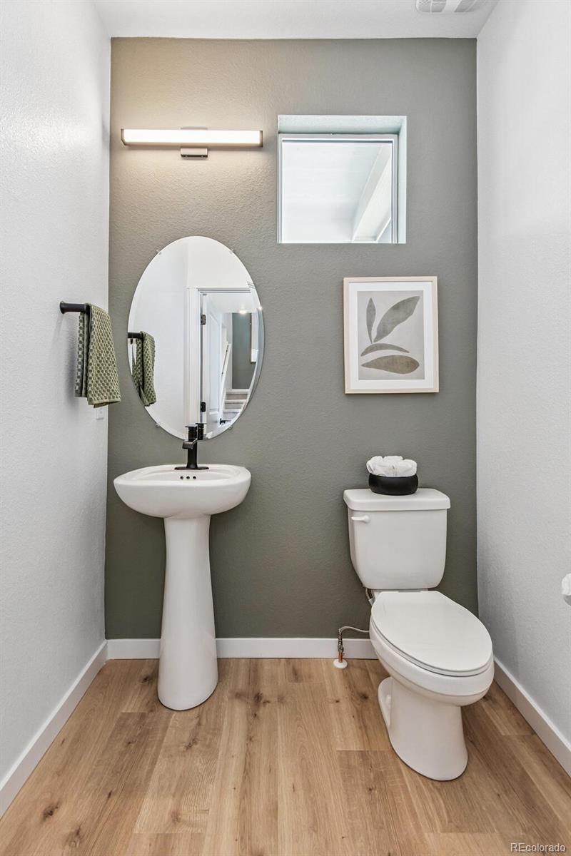 1381 South Chester Street, Unit B Denver, CO 80247 - Photo 11 of 18 a bathroom with a toilet sink and mirror