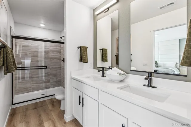 a bathroom with a double vanity sink and a mirror