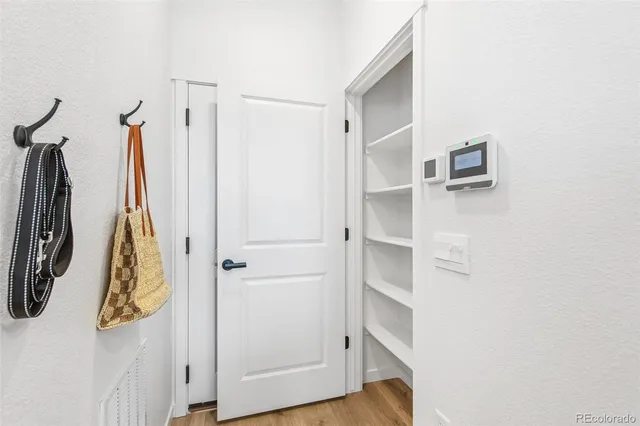 a view of walk in closet with clothes
