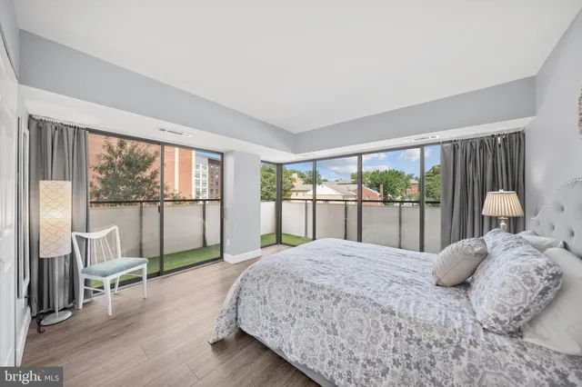 a bedroom with a large bed and a large window