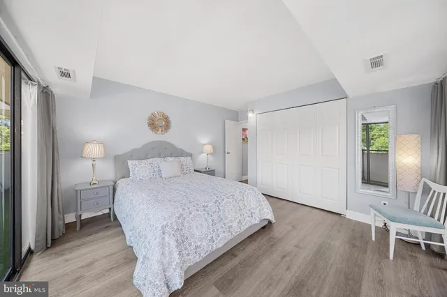 a bedroom with a bed and wooden floor