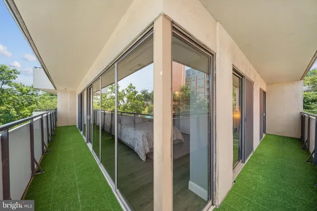 a balcony with view of swimming pool