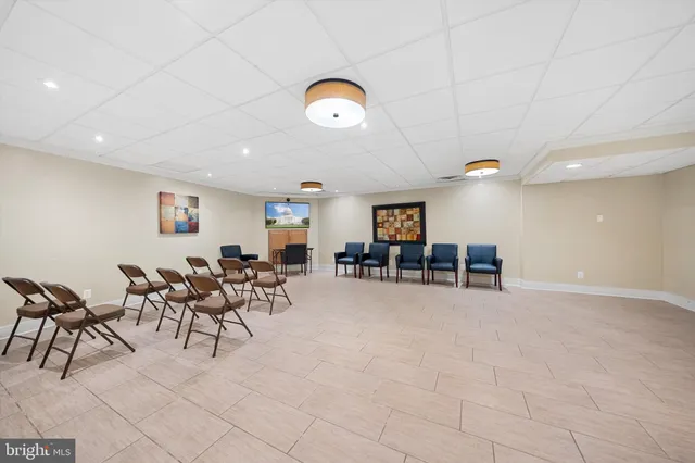 a view of a livingroom with furniture and a ceiling fan