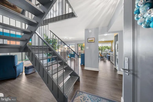 a view of entryway and hall with wooden floor