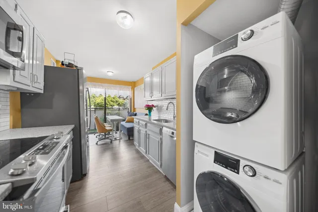 a kitchen with stainless steel appliances a stove a sink and a refrigerator