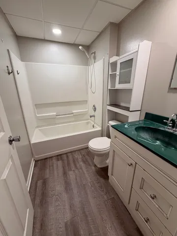 a view of an empty room and wooden floor