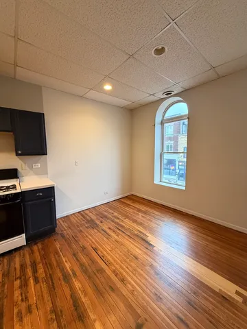 a view of a room with wooden floors and natural light