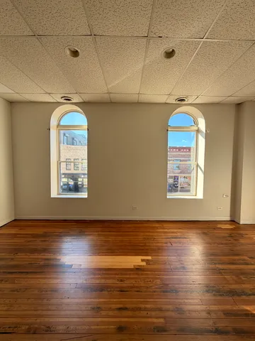 a view of a room with wooden floor and window