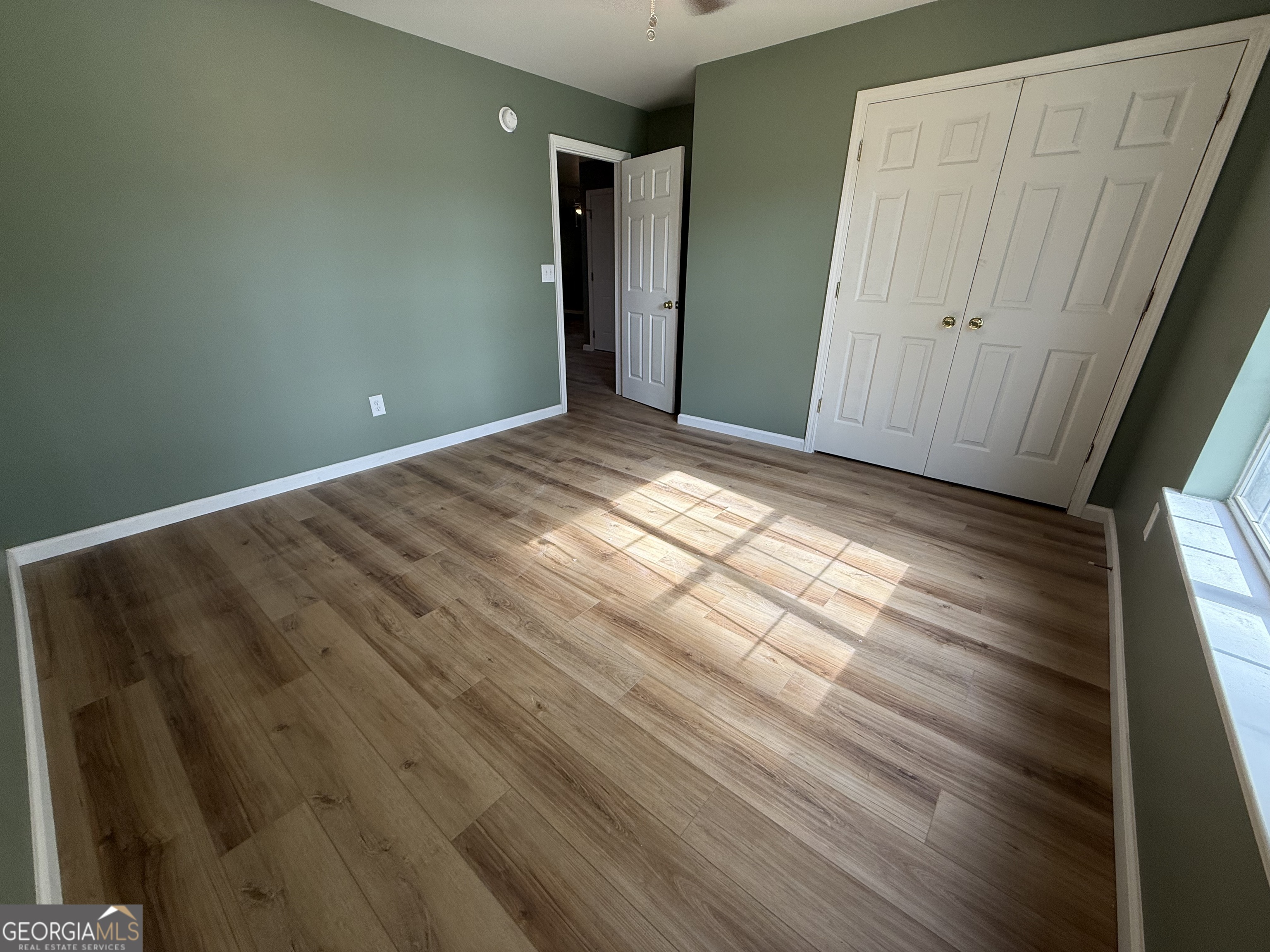 240 Sims Street Barnesville, GA 30204 - Photo 15 of 25 a view of empty room with wooden floor