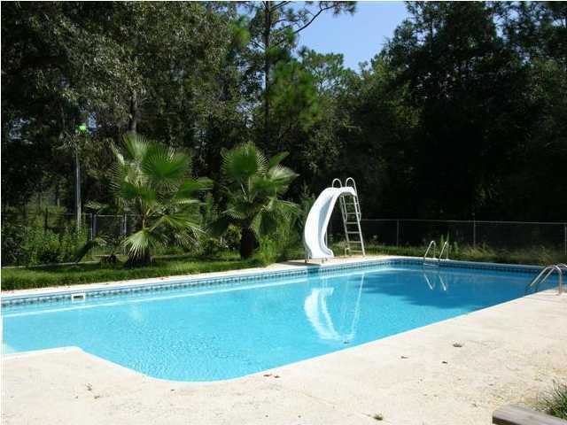 4555 Rainbird Rise Road Crestview, FL 32539 - Photo 2 of 32 a view of a swimming pool and a yard