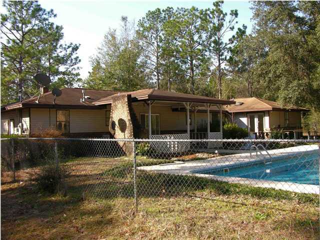 4555 Rainbird Rise Road Crestview, FL 32539 - Photo 24 of 32 a front view of a house with a yard