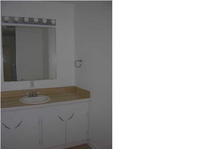 4555 Rainbird Rise Road Crestview, FL 32539 - Photo 26 of 32 a bathroom with a granite countertop sink and a mirror