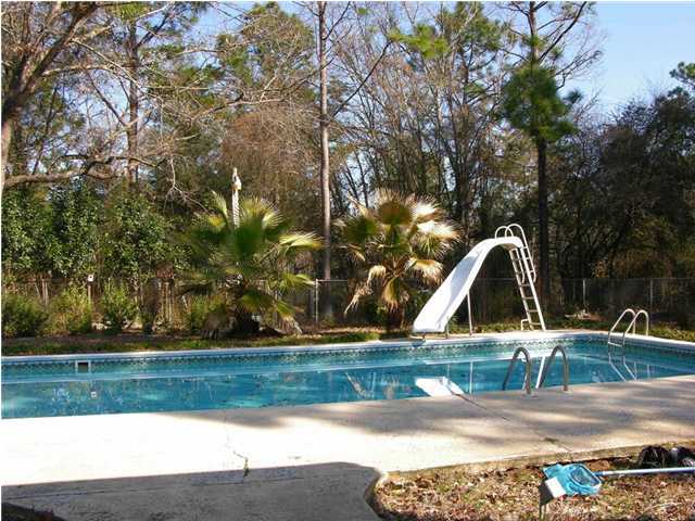4555 Rainbird Rise Road Crestview, FL 32539 - Photo 28 of 32 a view of backyard with wooden fence